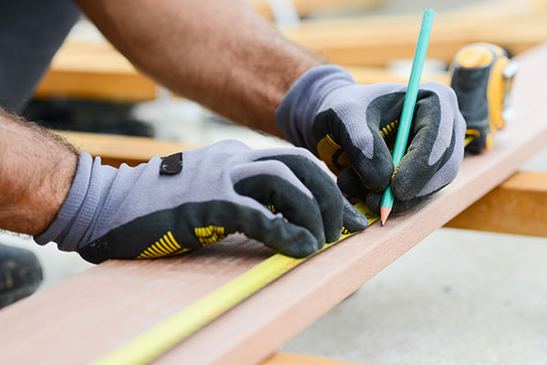 Worker marking wood with pencil