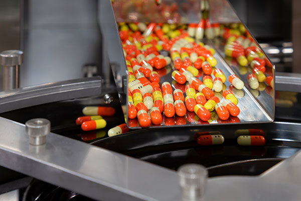 Pills coming down conveyor belt