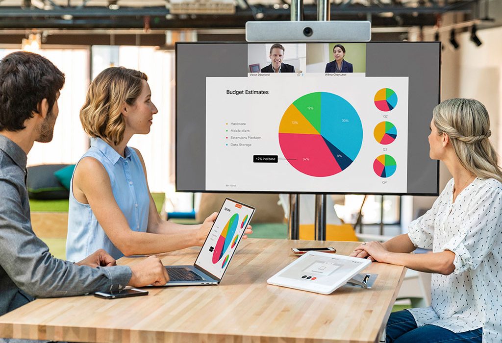 Workers in meeting room looking at screen