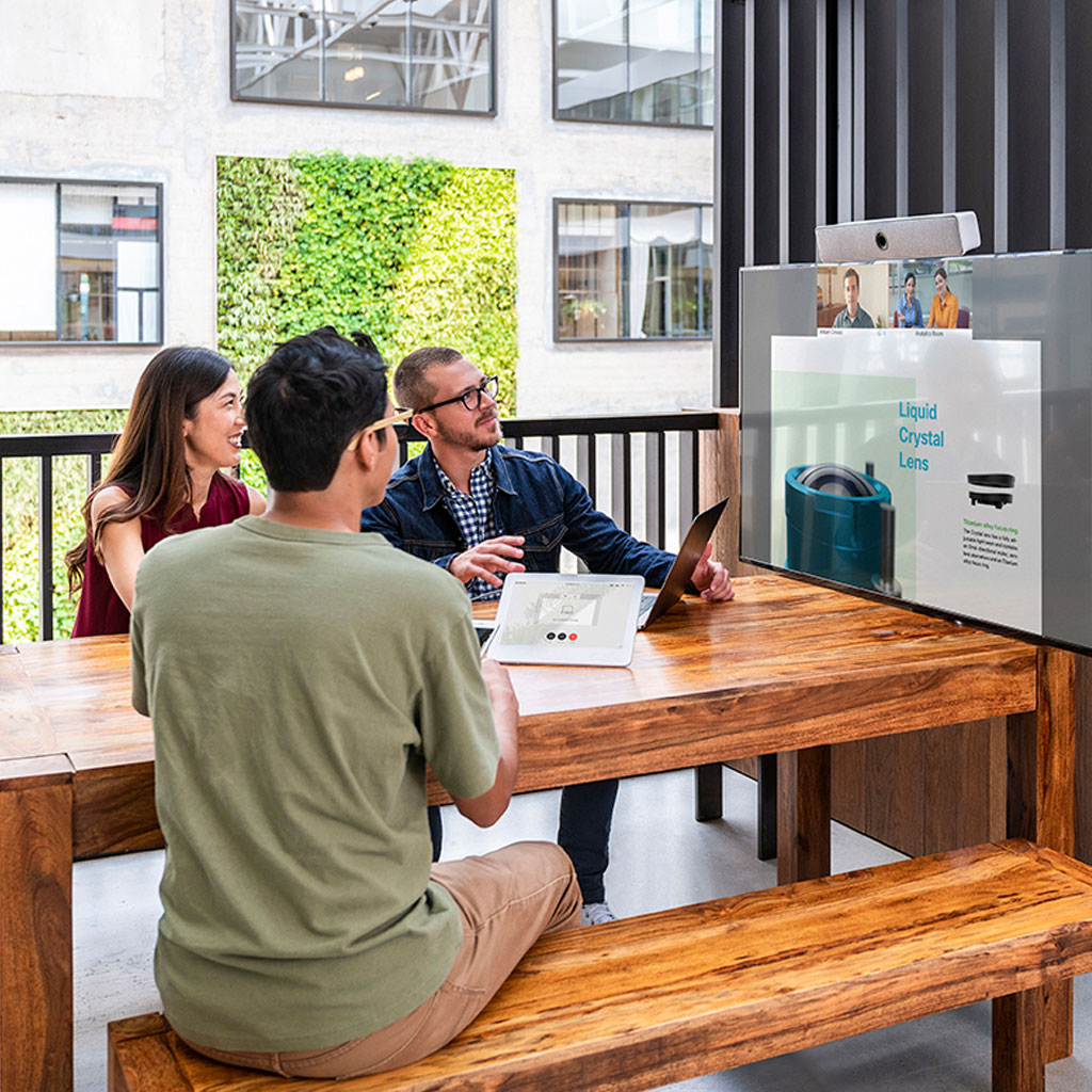 Workers in meeting room looking at screen