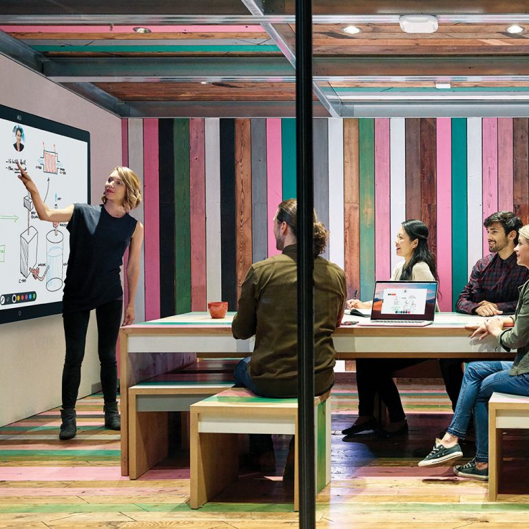 Workers in office looking at screen