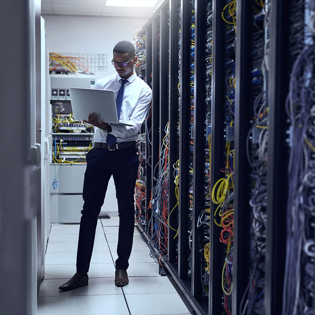 Man in server room on laptop