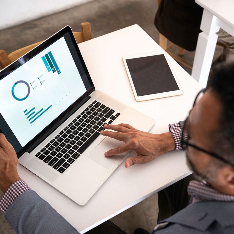 Worker on laptop with data