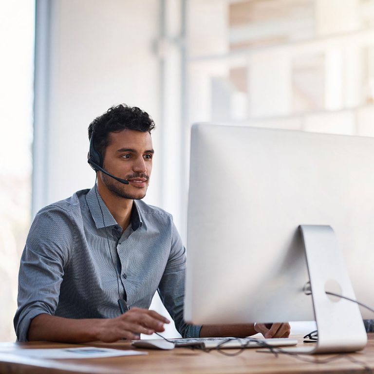 Worker with headset on monitor