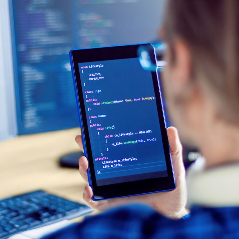 Worker on tablet looking at code