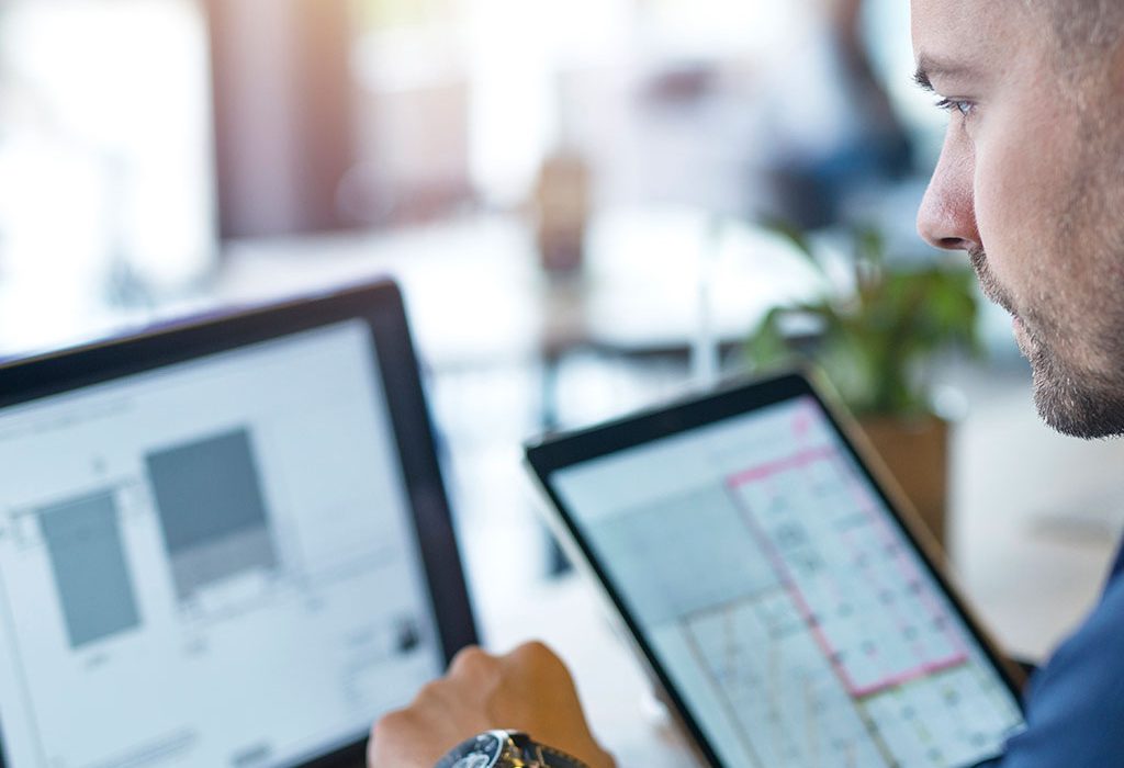 Worker with laptop and tablet
