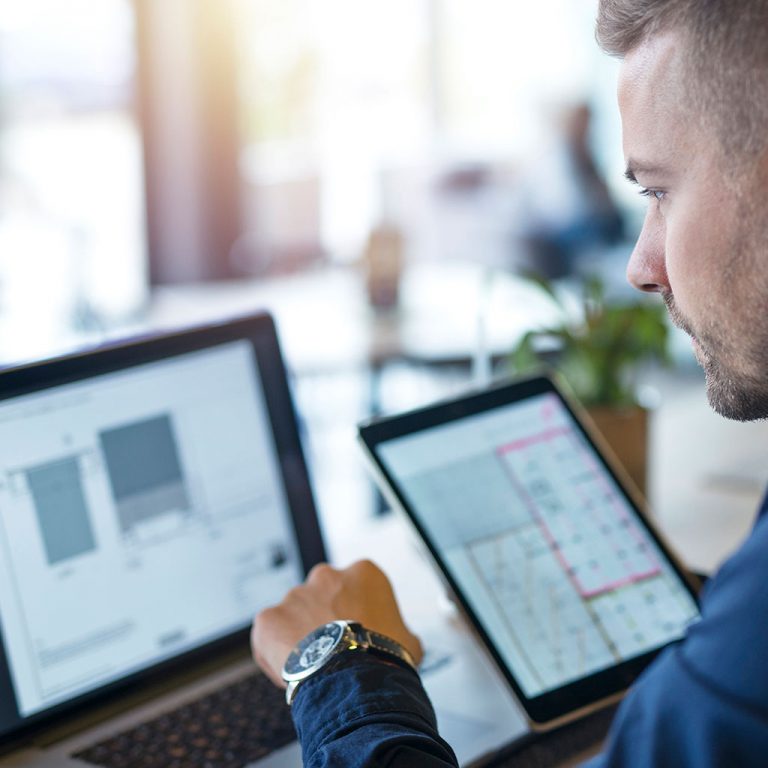 Worker with laptop and tablet